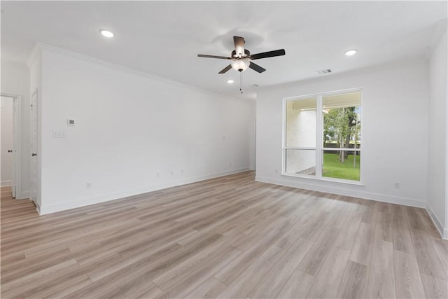 spare room with light hardwood / wood-style flooring, ceiling fan, and crown molding