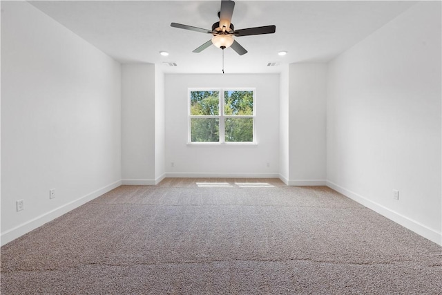 carpeted empty room featuring ceiling fan