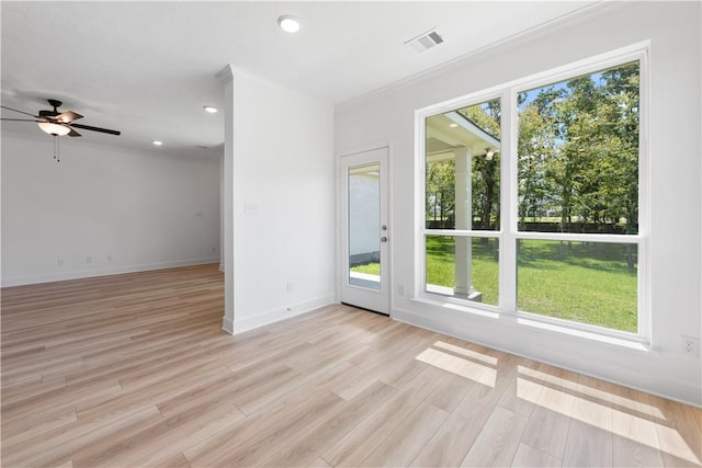 spare room featuring ceiling fan, light hardwood / wood-style floors, and ornamental molding