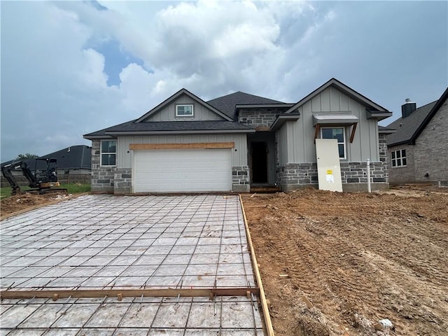 3577 Chantilly Path, Bryan, TX 77808 - view of front of home with board and batten siding, driveway, a garage, and stone siding