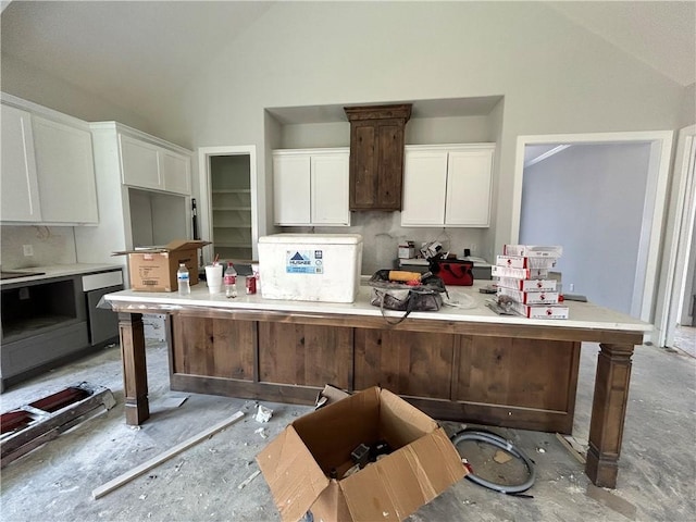 3577 Chantilly Path, Bryan, TX 77808 - kitchen featuring white cabinets, high vaulted ceiling, light countertops, and a center island