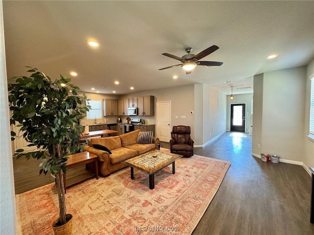 living room with ceiling fan and hardwood / wood-style flooring