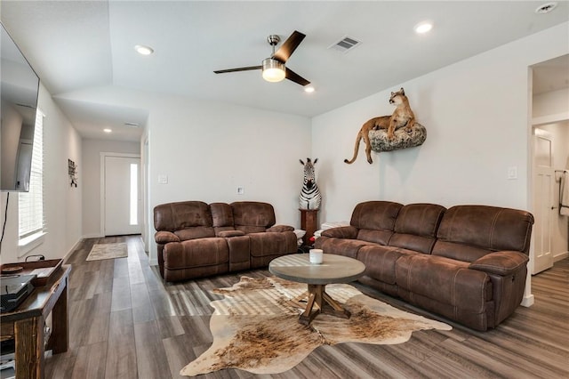 living room with ceiling fan, dark hardwood / wood-style floors, and lofted ceiling