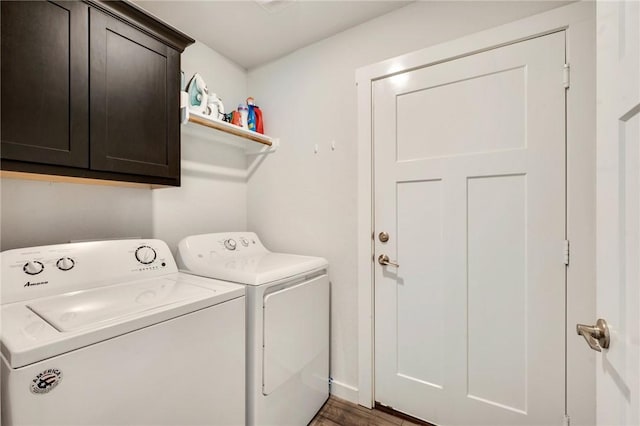 laundry area featuring dark hardwood / wood-style flooring, separate washer and dryer, and cabinets