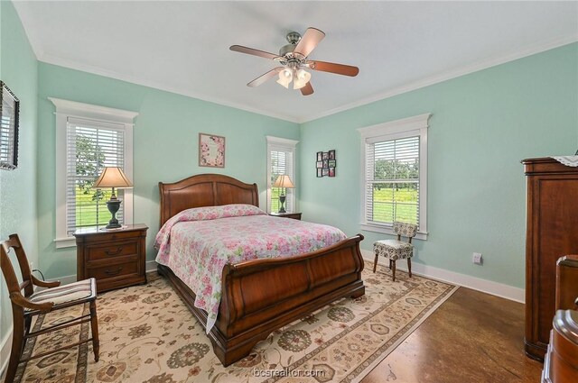 bedroom featuring multiple windows, ceiling fan, and ornamental molding