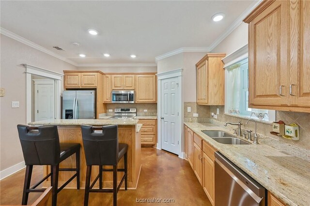 kitchen featuring a center island, sink, appliances with stainless steel finishes, and tasteful backsplash