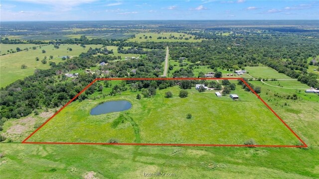 birds eye view of property featuring a rural view and a water view