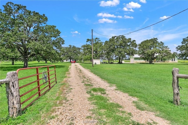 view of community featuring a rural view and a lawn