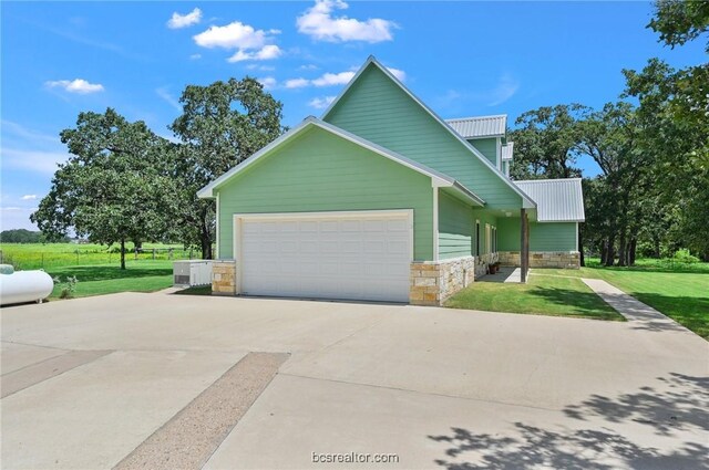 view of front of home with a garage and a front lawn