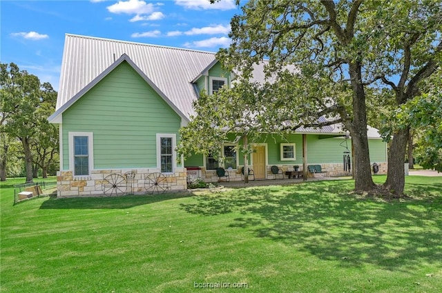 back of property featuring a yard