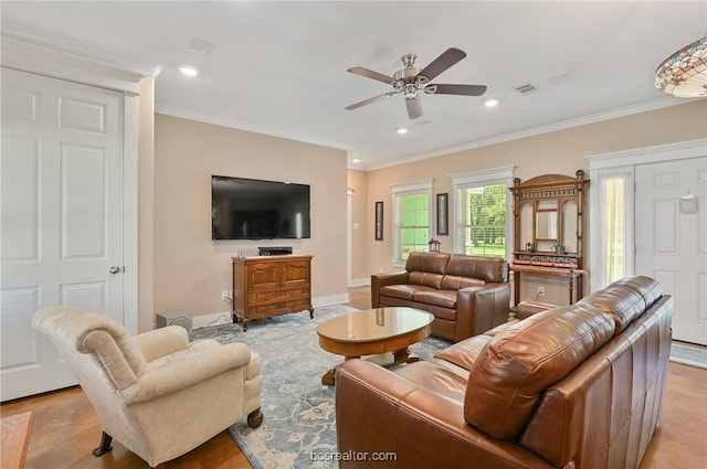 living room with ceiling fan and ornamental molding