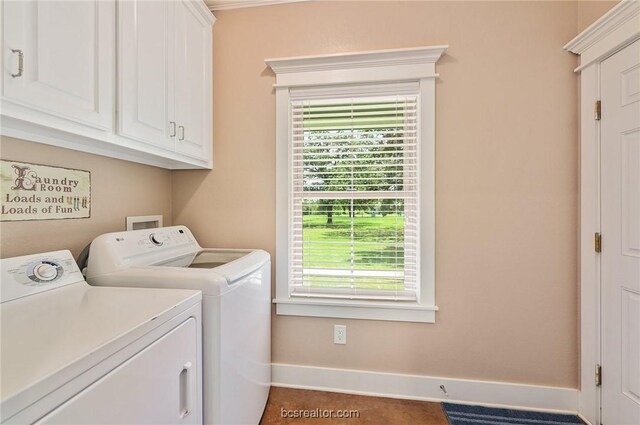 laundry area with cabinets, a wealth of natural light, and washing machine and clothes dryer