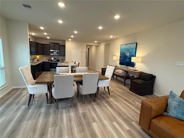 dining space with light hardwood / wood-style floors