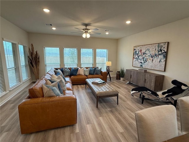 living room featuring ceiling fan and light wood-type flooring