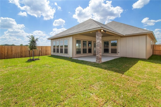 back of house featuring a yard and a patio