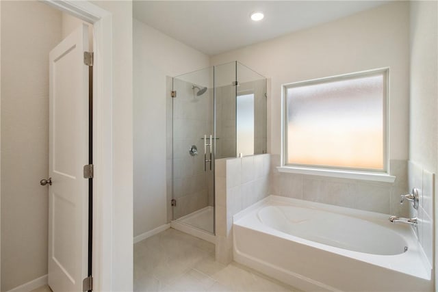 bathroom featuring shower with separate bathtub and tile patterned flooring