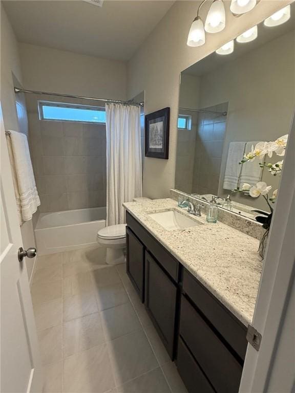 full bathroom featuring tile patterned flooring, vanity, toilet, and shower / bath combo with shower curtain