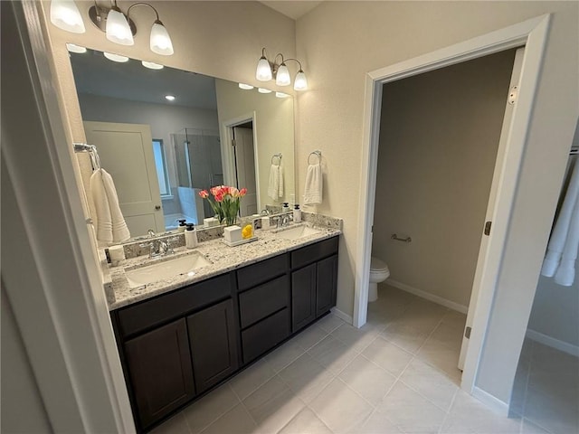 bathroom featuring vanity, tile patterned flooring, a shower with door, and toilet