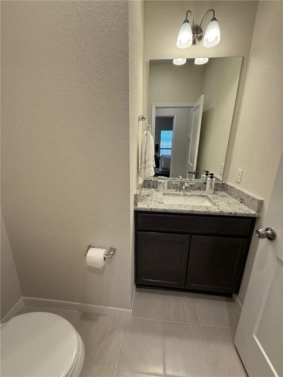 bathroom featuring vanity, toilet, and tile patterned flooring