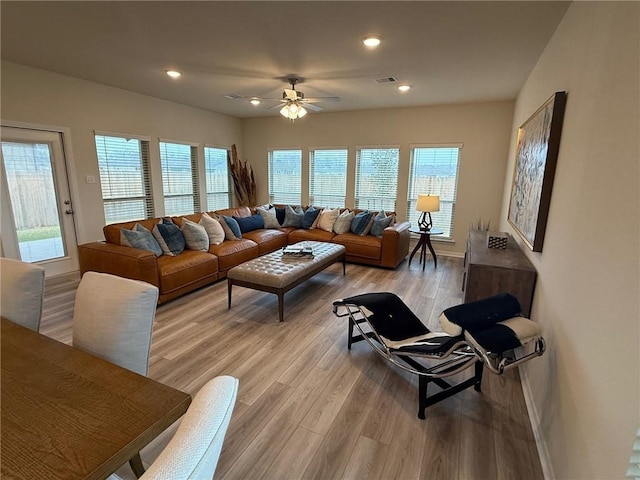 living room featuring ceiling fan and light wood-type flooring