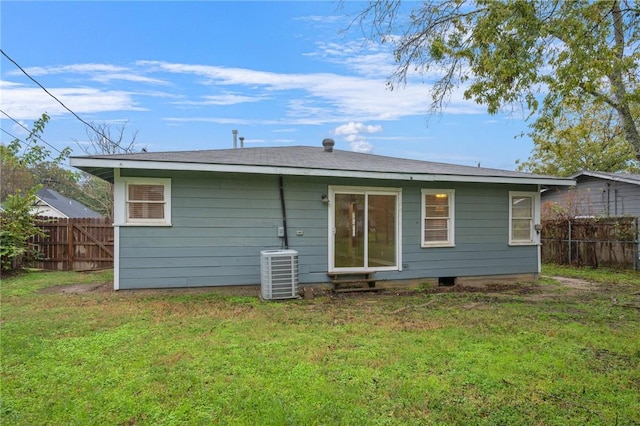 back of house featuring a lawn and cooling unit