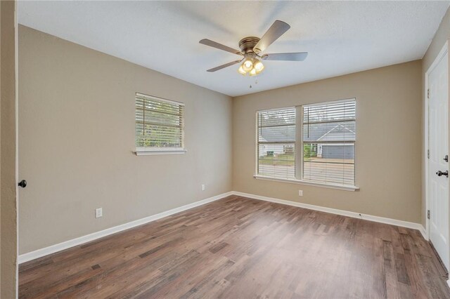 empty room with hardwood / wood-style floors and ceiling fan