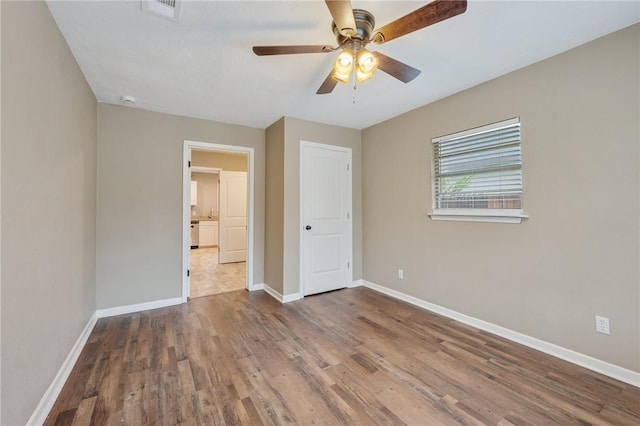 unfurnished bedroom featuring wood-type flooring and ceiling fan