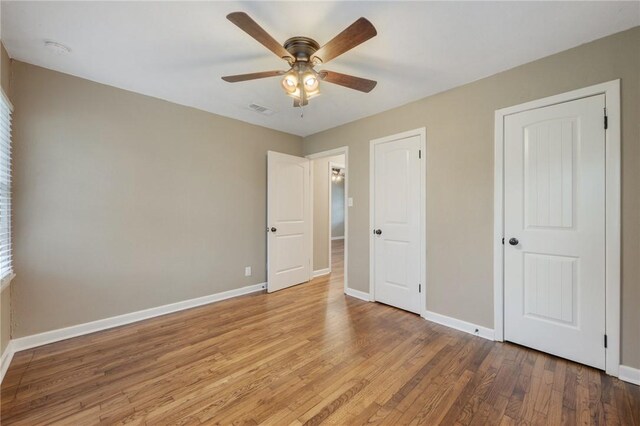 unfurnished bedroom with hardwood / wood-style floors and ceiling fan