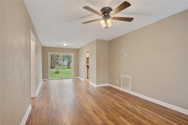 spare room featuring light wood-type flooring and ceiling fan