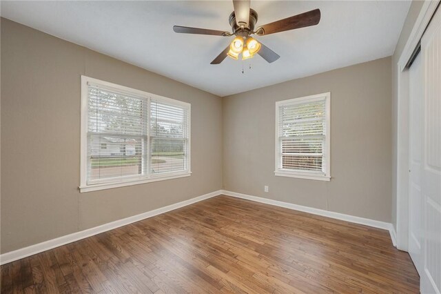 unfurnished room featuring ceiling fan and hardwood / wood-style floors