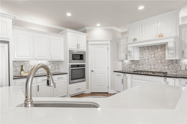 15658 Long Creek Ln, College Station, TX 77845 - kitchen featuring stainless steel appliances, a sink, white cabinets, backsplash, and crown molding