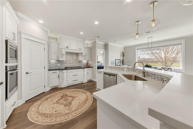 15658 Long Creek Ln, College Station, TX 77845 - kitchen with a sink, white cabinets, ornamental molding, appliances with stainless steel finishes, and decorative backsplash