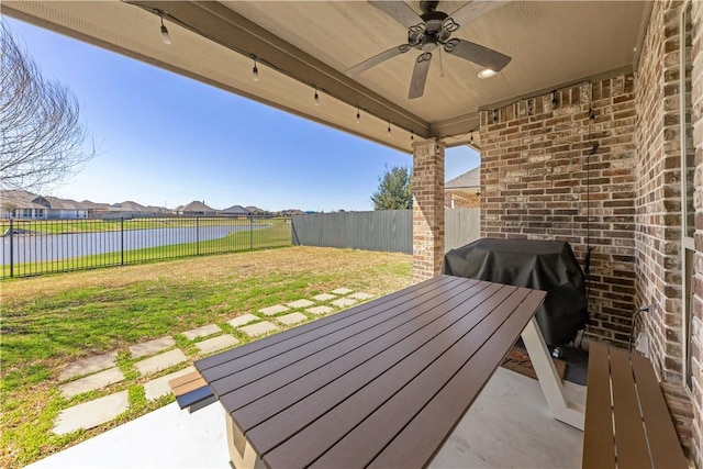 15658 Long Creek Ln, College Station, TX 77845 - view of patio featuring ceiling fan, grilling area, a fenced backyard, and a water view