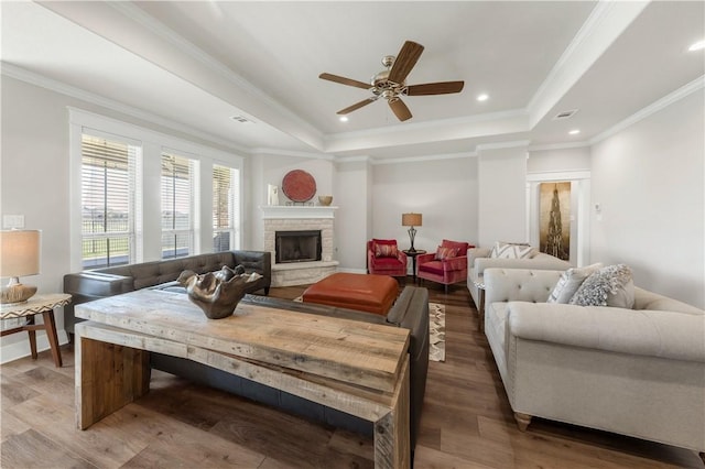 15658 Long Creek Ln, College Station, TX 77845 - living room with wood finished floors, a fireplace, a raised ceiling, and crown molding