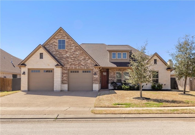 15658 Long Creek Ln, College Station, TX 77845 - view of front of house featuring driveway, a garage, fence, and brick siding