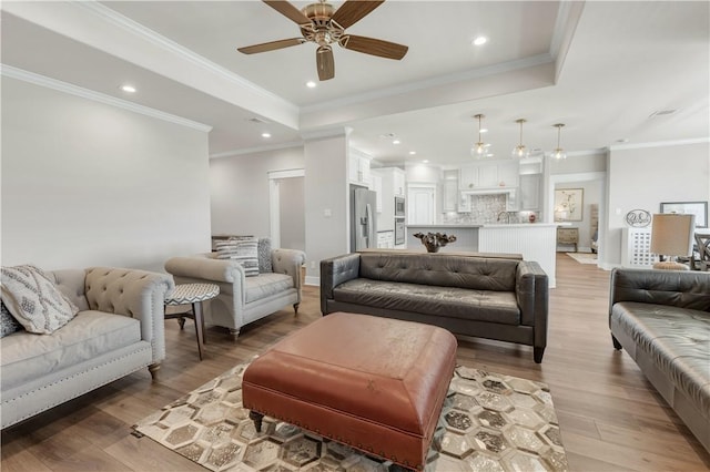 15658 Long Creek Ln, College Station, TX 77845 - living area with a tray ceiling, recessed lighting, light wood-style flooring, and crown molding
