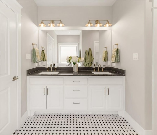 15658 Long Creek Ln, College Station, TX 77845 - bathroom featuring a sink, baseboards, and double vanity