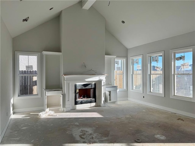 unfurnished living room featuring a fireplace with flush hearth, a wealth of natural light, and baseboards