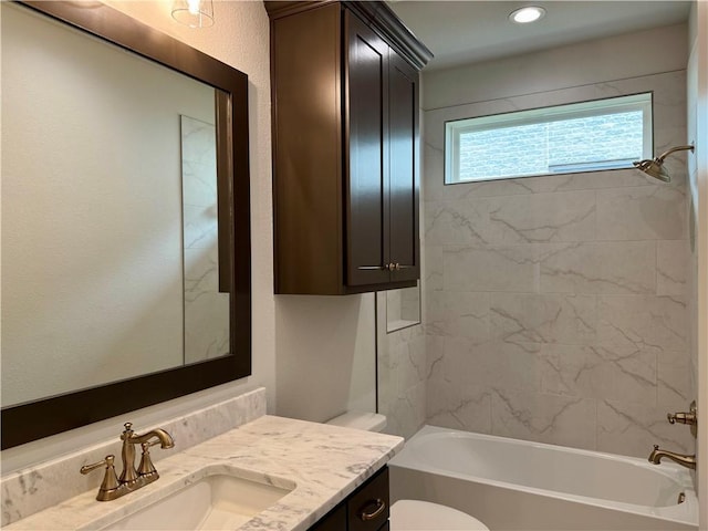 bathroom featuring recessed lighting, vanity, bathtub / shower combination, and toilet
