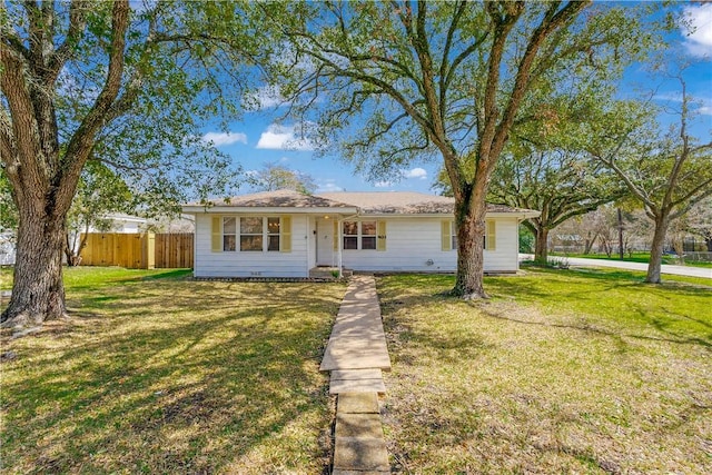 view of front of house with a front yard and fence