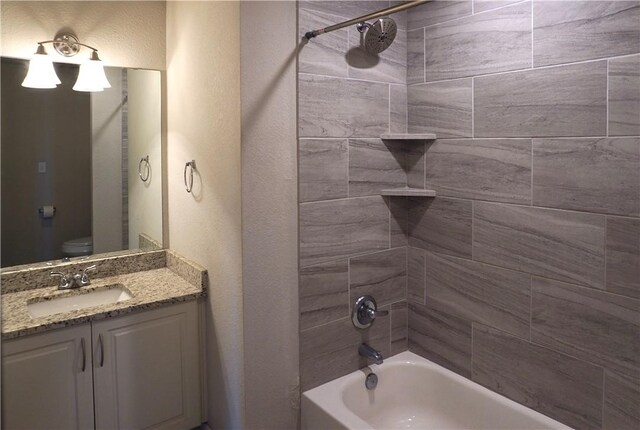 2011 Stubbs Dr, Bryan, TX 77807 - full bath with shower / bath combination, vanity, toilet, and a textured wall