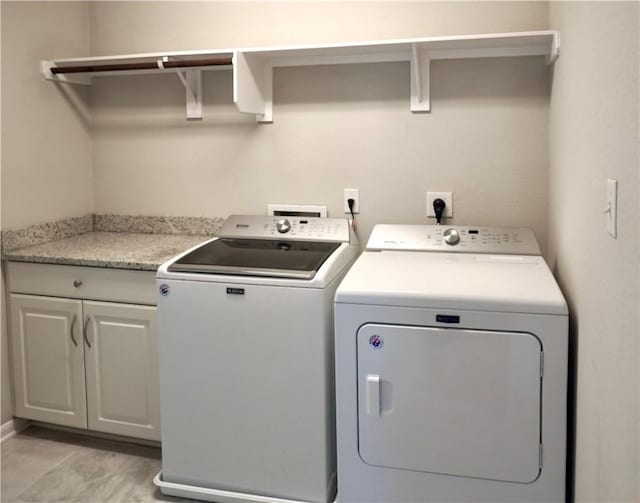 2011 Stubbs Dr, Bryan, TX 77807 - washroom featuring independent washer and dryer and cabinet space