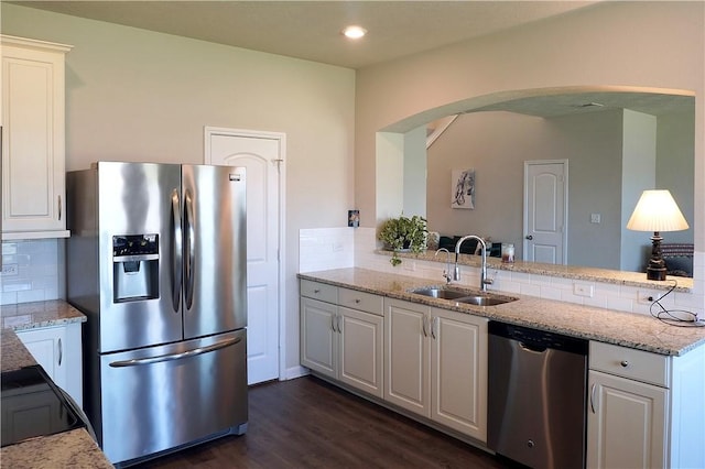 2011 Stubbs Dr, Bryan, TX 77807 - kitchen with appliances with stainless steel finishes, a sink, arched walkways, decorative backsplash, and white cabinets