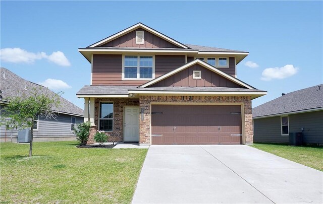 2011 Stubbs Dr, Bryan, TX 77807 - craftsman-style home with board and batten siding, central air condition unit, a front lawn, concrete driveway, and brick siding