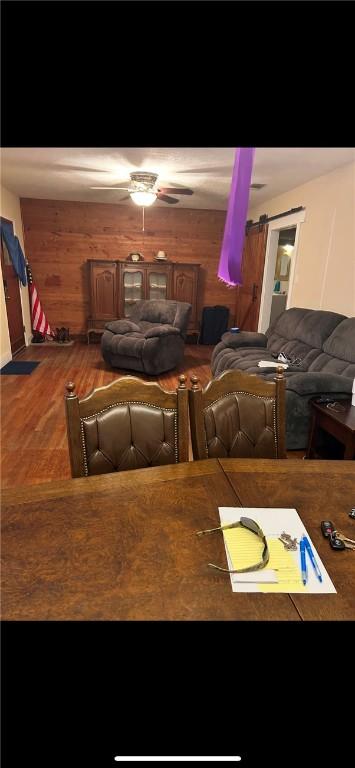 home theater featuring a barn door and ceiling fan