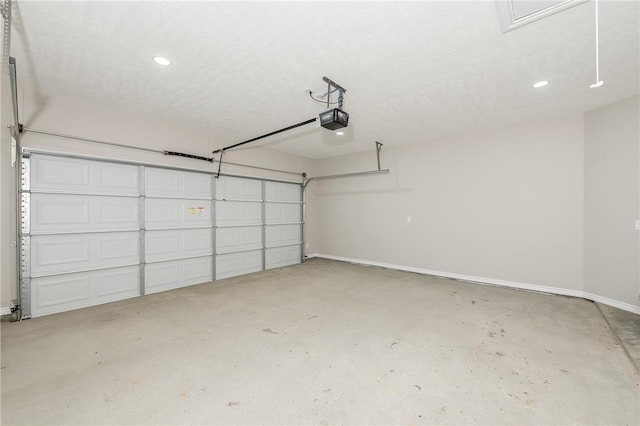 garage featuring a garage door opener and baseboards