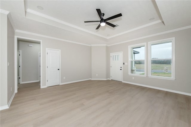 unfurnished living room with light wood-style floors, baseboards, a raised ceiling, and a ceiling fan