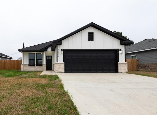 modern farmhouse featuring brick siding, board and batten siding, fence, concrete driveway, and a garage