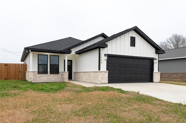 modern farmhouse with fence, driveway, an attached garage, a shingled roof, and brick siding