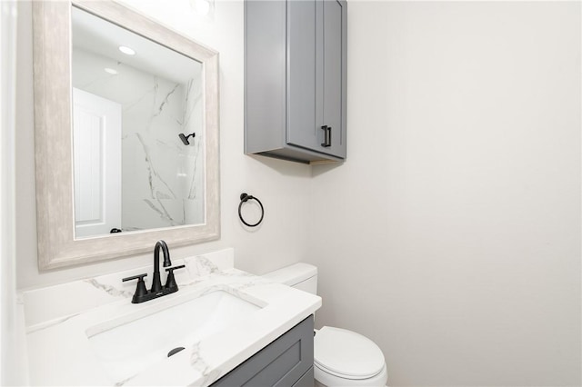 bathroom featuring toilet and vanity